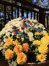Two resin bluebirds on sticks in white and yellow mums